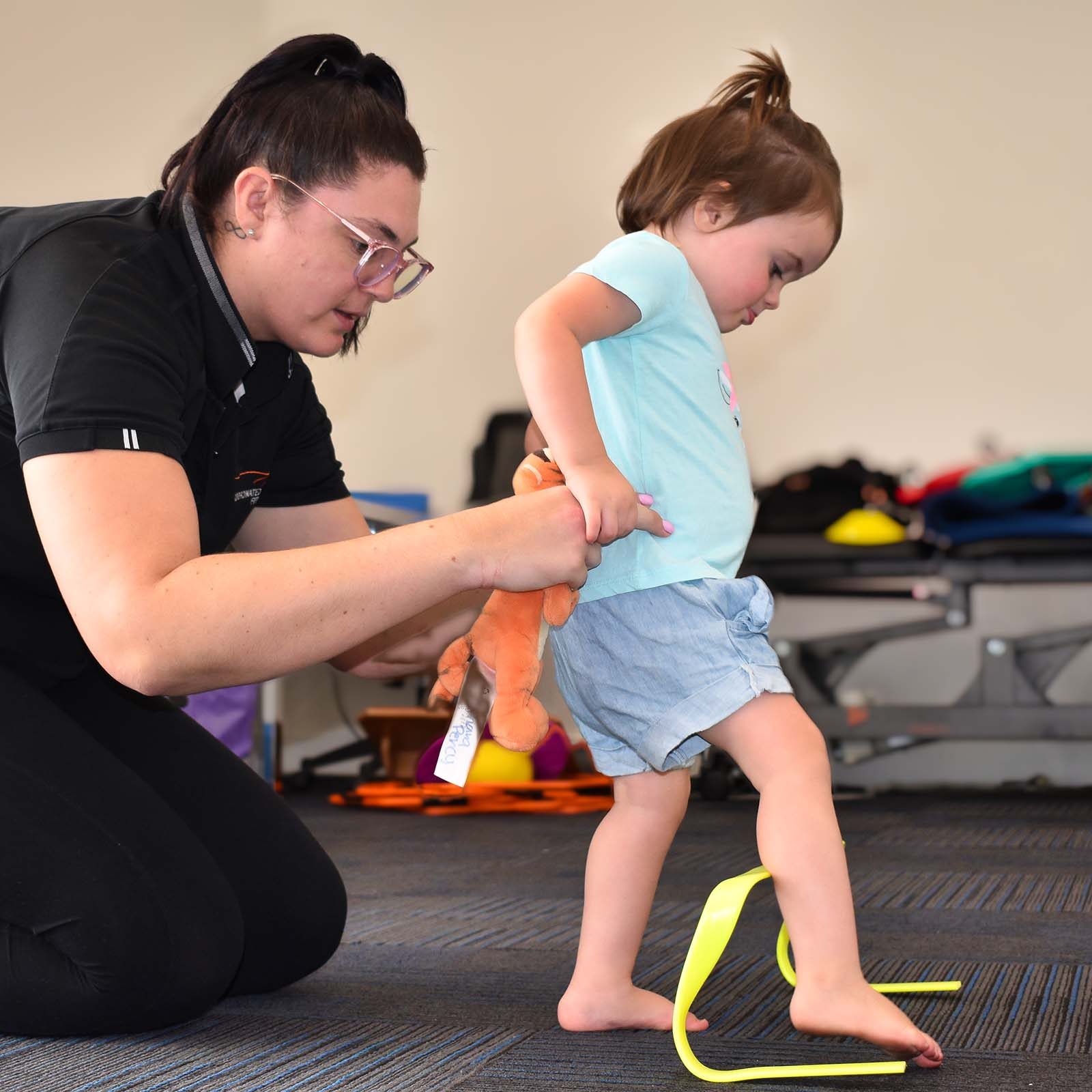 instructor with kid exercises